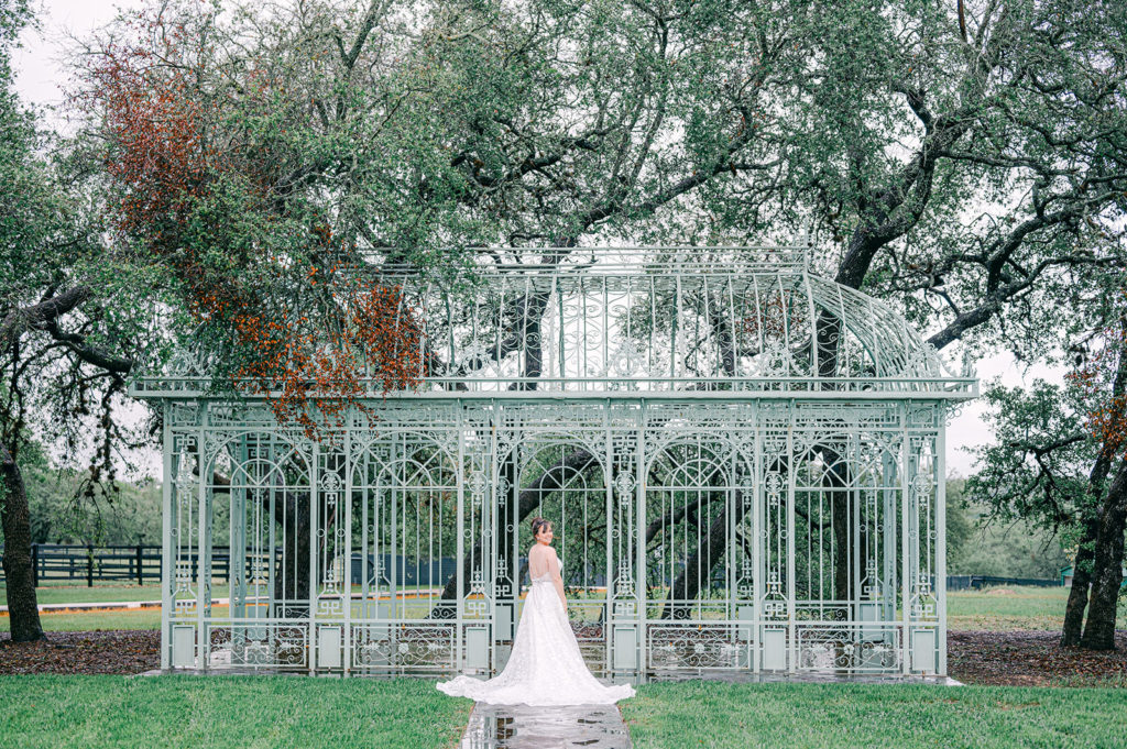 photo of a bride in front of the green cathedral at Ma Maison, Austin wedding venue